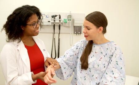 UVA medical student caring for patient at the Clinical Skills Center.