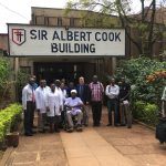 Mengo Hospital-Dr. Haglund, Dr. Kitya, Dr. Kiryabwire, residents & biomed technician in front of main building (Mission hospital established by Sir Albert Cook)