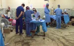 Photo of operating room with two ongoing surgeries
