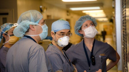University of Virginia Anesthesia Residents with an Attending check their assignments on the Big Board in the OR..