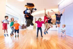 The Cav Man and Children Jump in the air for joy at the UVA Children's Hospital