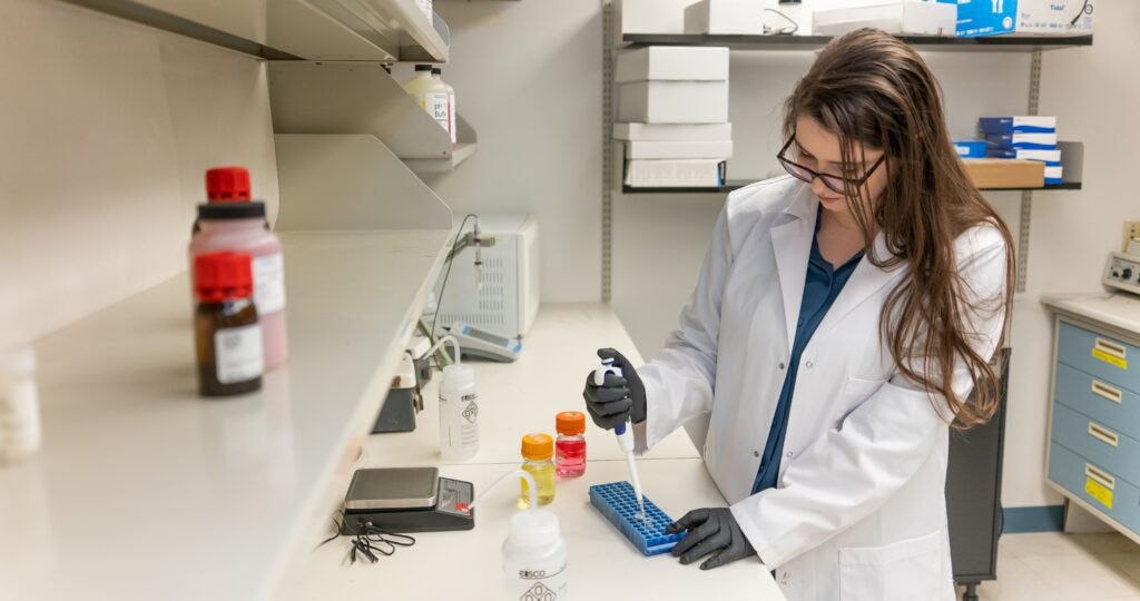 girl pipetting in lab