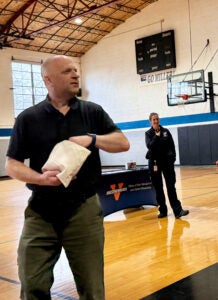 At the UVA OPMOS Presentation at Miller School, Crozet Fire Chief Gary Dillon tossed Narcan Trainers in to the bleachers as Charlottesville Albemarle Rescue Squad Chief Virginia Leavell looks on.
