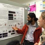 Picture of UVA B.I.G. researcher Sachin Gadani explaining his poster at UVA symposium.
