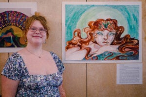 Artist with Art at Gallery