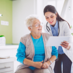 Patient and doctor looking at a piece of paper and smiling.