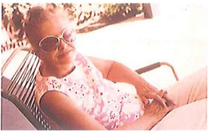 A woman wearing sunglasses sitting in a chair