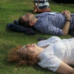 two people laying in a field