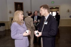 Susan Smith, Chief of the Risk Development for Department of Homeland Security, and Chris Holstege hold a sidebar conversation during a session break.