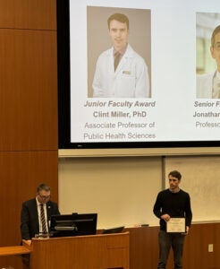 Picture of Associate Professor Clint Miller receiving Junior Faculty award at ceremony.