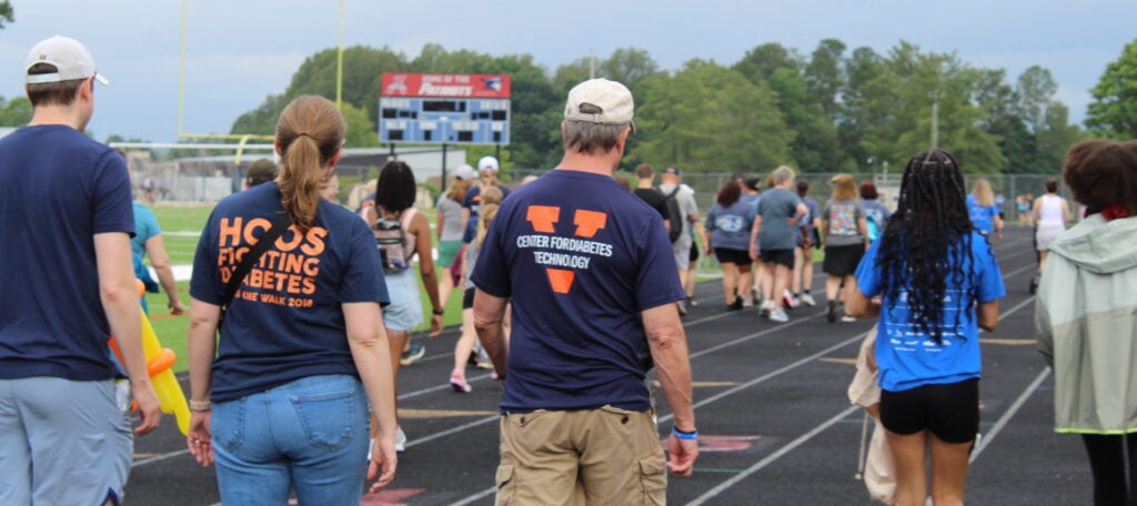Community members walking around a high school track