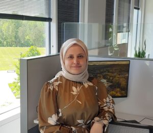 Meryem sitting at a desk.