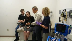 group of researchers having a discussion about an insulin pump