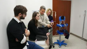 group of researchers discussing the lab results of the YSI machine