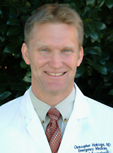 doctor Chris Holstege smiling and wearing his white lab coat