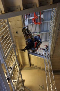 a group practicing a rescue drill in a stairwell