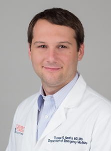 doctor Thomas Hartka wearing his white lab coat