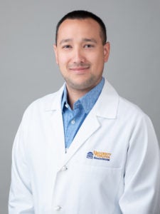 doctor Matthew Kongkatong smiling and wearing white lab coat