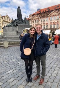 portrait of Jordan Hughes and significant other abroad in a cobbled square