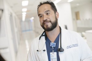 portrait of doctor George Glass in his white coat with a stethoscope