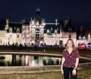Erin standing in front of an estate at night