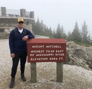 Greyson standing at Mount Mitchell elevation sign