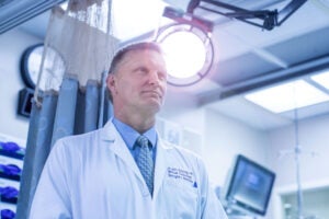 doctor Chris Holstege standing in emergency room wearing white lab coat