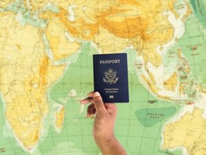 someone holding a passport in front of a map of the eastern hemisphere