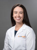 headshot of doctor Sarah Wendel wearing a white lab coat and smiling at the camera