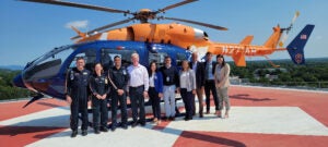 Group photo in front of Pegasus helicopter; photo includes Department of Emergency Medicine Chair Doctor Robert O'Connor as well as CEO Wendy Horton