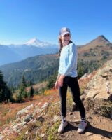 Jennifer outside on a sunny mountainous hike