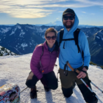 Nick and Sam on a snowy, sunny mountainous hike