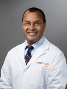 Neeral Shah, MD, in white coat 