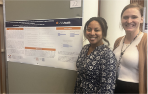 Dr. Echo Buffalo-Ellison (left) and Dr. Sarah Dalrymple (right) stand, smiling, with their poster assessing the effectiveness of the Family Medicine Resident Mentoring Program.