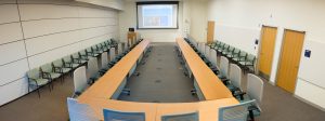 Photo: Education Resource Center Room B at UVA Health. Boardroom set up with single projection screen.