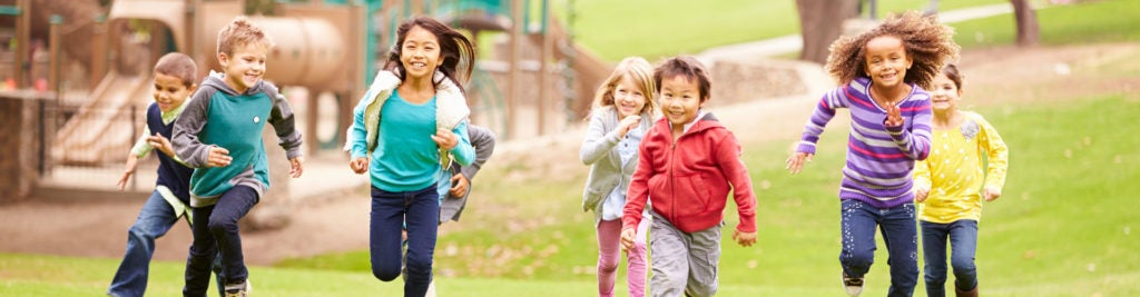 Children running in a playground banner