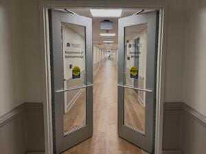 Brightly lit corridor with UVA-blue accents and new flooring inside Department of Ophthalmology