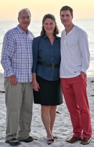 The Miller family standing on the beach 