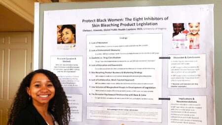 Chelsea Edwards stands next to her presentation poster.