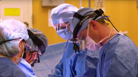plastic surgeons working on patient