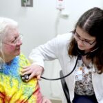 A doctor using a stethescope