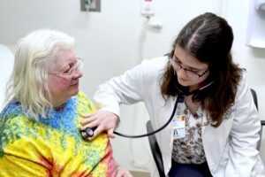 A doctor using a stethescope
