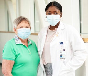 A doctor and a patient standing in a hospital room