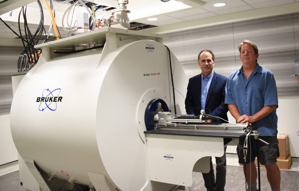 UVA Radiology Research faculty Dr. Stuart Berr and R. Jack Roy stand with the new Bruker BioSpec 94/20 9.4T MRI system for rodent imaging and spectroscopy