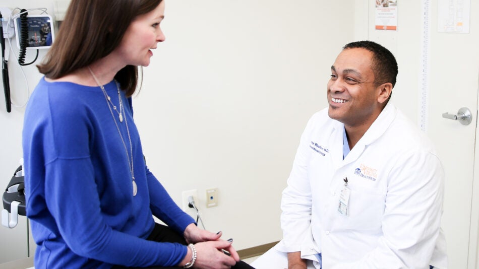 uva radiologist smiles and talks with patient