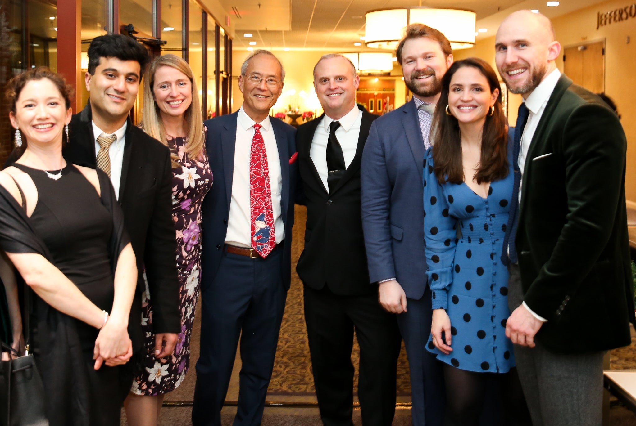 Department Chair Dr. Alan Matsumoto (center, red tie) stands with Dr. Carrie Rochman, left, and Dr. Drew Lambert, right, along with Radiology residents at the 2019 Department Holiday Party