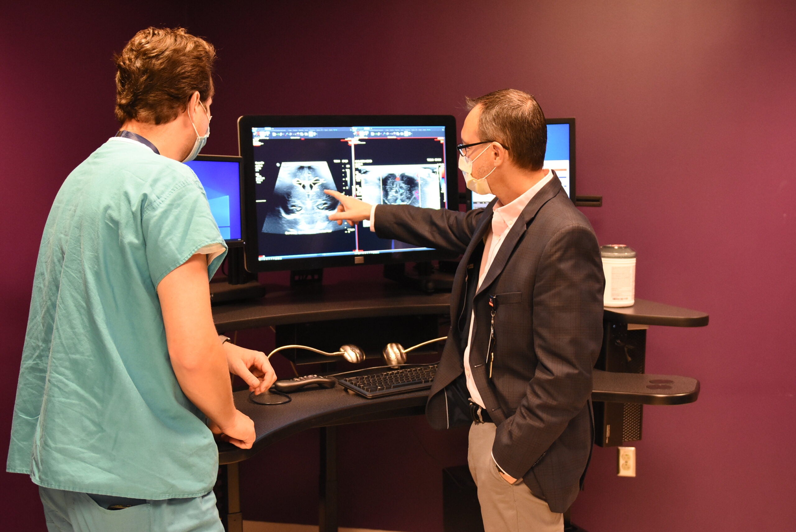 uva radiology faculty analyzes scan with fellow