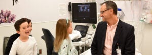 UVA radiologist smiles with kids