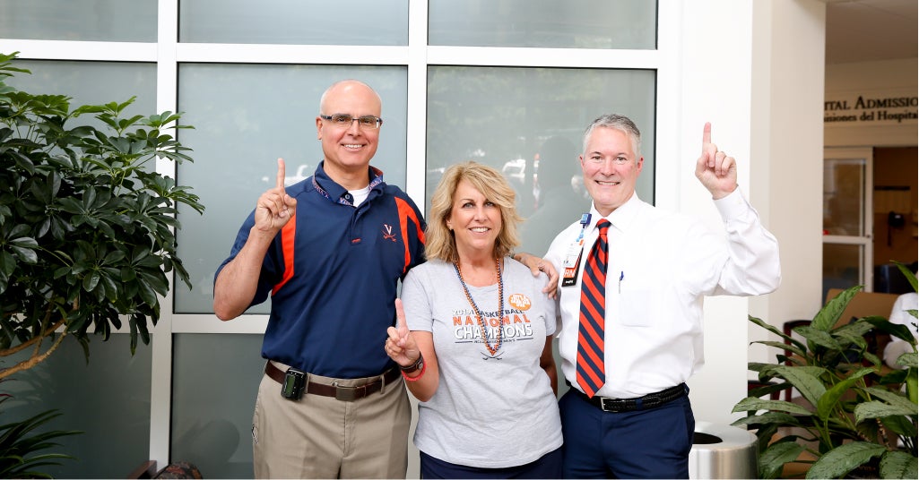 UVA Radiology staff and faculty pose together in UVA-branded attire after the 2018 Men's Basketball Team won the NCAA Championship