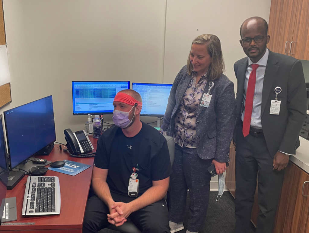 UVA Health's Cody Desper shows the Department of Radiology & Medical Imaging's Virtual Cockpit to Wendy Horton and Abdi Somo.